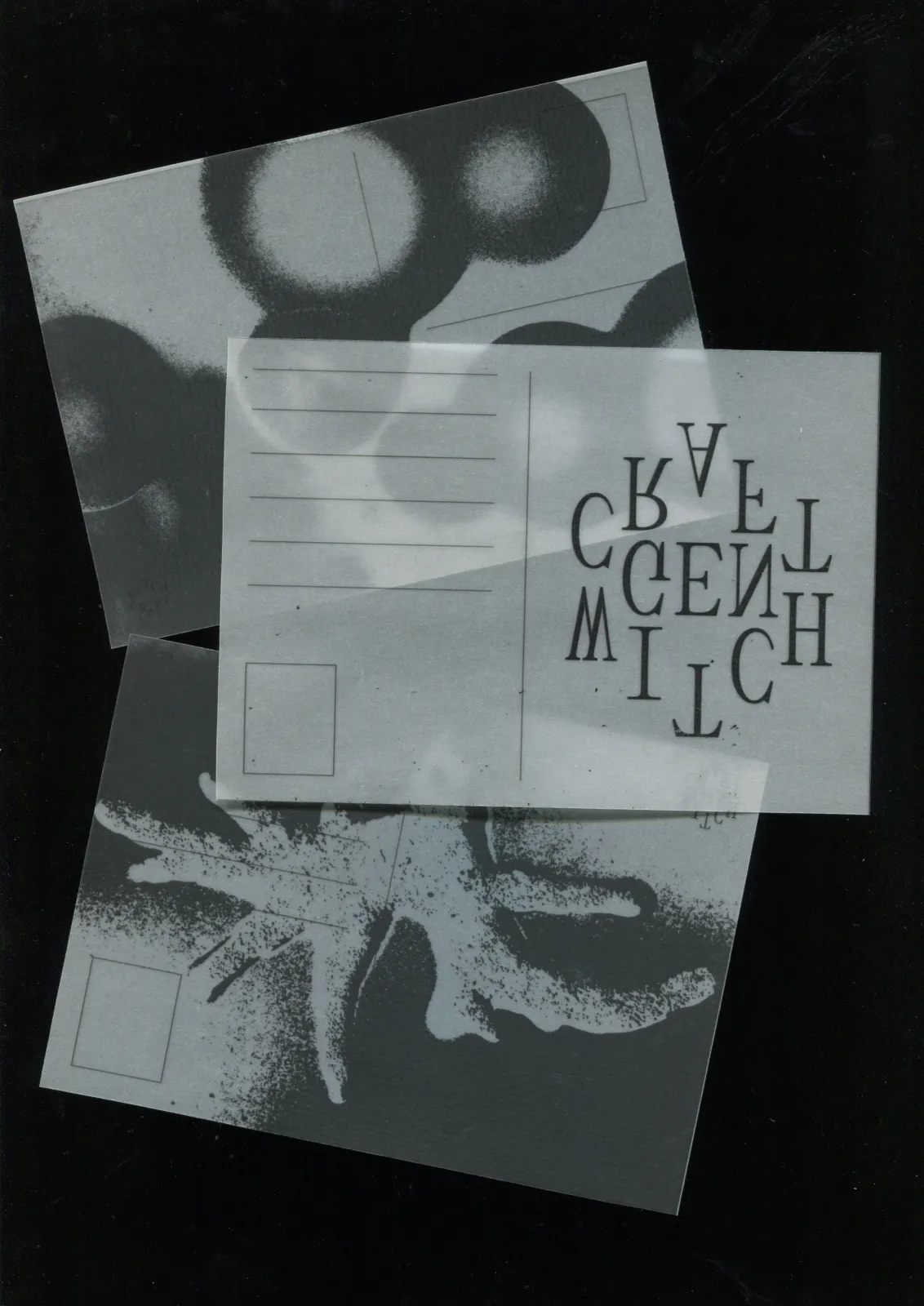 Photograph of translucent Witchcraft postcards layered on black